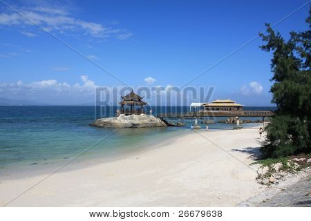 wooden pavilion, azure sky, white sand and blue sea --- Sanya, China