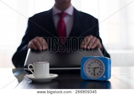 Businessman Closes The Laptop And Drinks Coffee. The Concept Of Rest And Time Management.