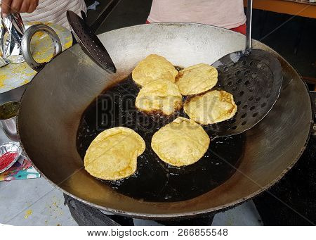Fried Food Kachauri Puri Pile Deep Fried In Oil In A Big Steel Frying Pan