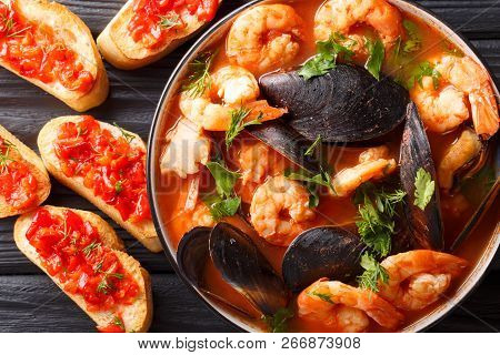 French Bouillabaisse Fish Soup With Shrimps, Fish Fillets And Mussels Closeup In A Bowl. Horizontal