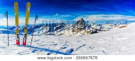 Ski in winter season, mountains and ski touring backcountry equipments on the top of snowy mountains in sunny day, Verbier Switzerland.