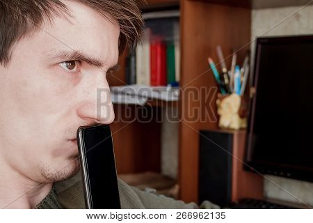 The Guy Suspiciously Looks Up, Closed The Rum With A Black Smartphone