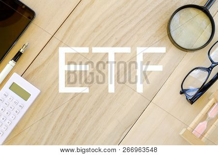 Business And Finance Concept. Top View Of Stationary On Wooden Background Written With Etf(exchange 