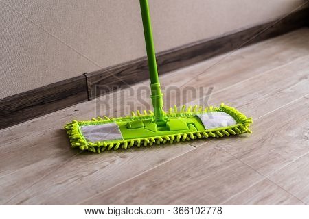 Cleaning Gear. Mopping A Living Room Floor. Green Mop.