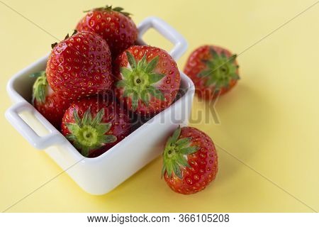Red Fresh Strawberry Berries In White Ceramic Dishes On A Colored Background, Copyspace