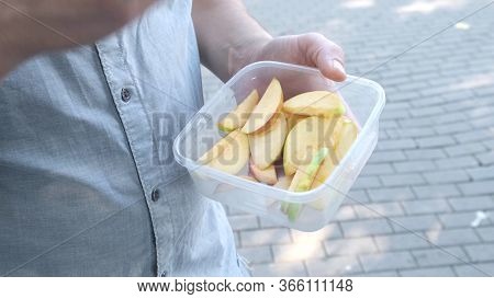 Man Hand, Eat Pieces Sliced The Apples From The Container.