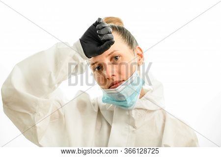 Woman With Downcast Mask Wipes Her Forehead With Hand