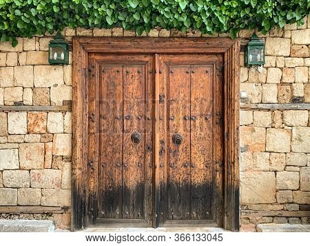An Old Historical Stone Wall With A Wooden Door Gate In Antalya Old Town Kaleici, Turkey. Ottoman Ti
