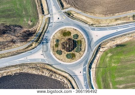Top Down Aerial View Of A Traffic Roundabout On A Main Road In An Urban Area