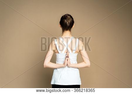 A Beautiful Young Girl Is Meditating In The Pose Of Parshvottanasana. Marichiasana. Consideration An
