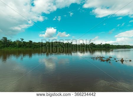 Teal Sky And Green Trees With Suriname River Landscape