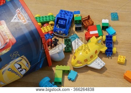 Poznan, Poland - May 14, 2020: Mix Of Lego Duplo Blocks Including Plane Laying On A Wooden Floor.