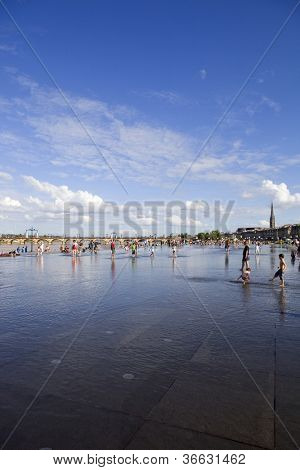BORDEAUX, FRANCE - AUGUST 8: Bordeaux water mirror full of people in one of the hotest summer days, having fun in the water, on August 8, 2012 in Bordeaux, France.
