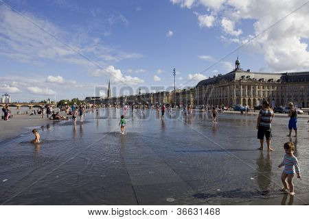 BORDEAUX, FRANCE - AUGUST 8: Bordeaux water mirror full of people in one of the hotest summer days, having fun in the water, on August 8, 2012 in Bordeaux, France.