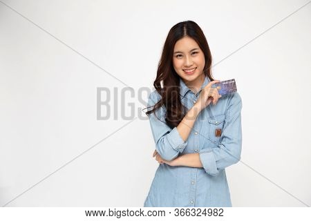 Portrait Of Asian Women Wearing Blue Jean Shirt Holding Credit Card And Smile Isolated Over White Ba