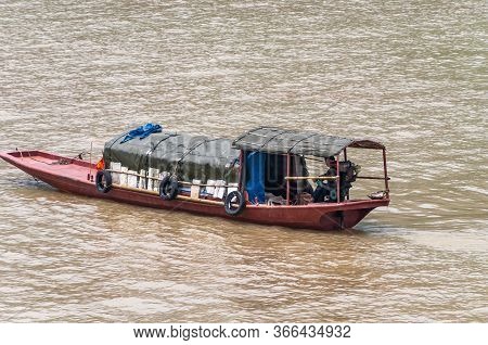 Fengdu, Chongqing, China - May 8, 2010: Yangtze River. Closeup Of Small Red Sloop With Dark Green Ca