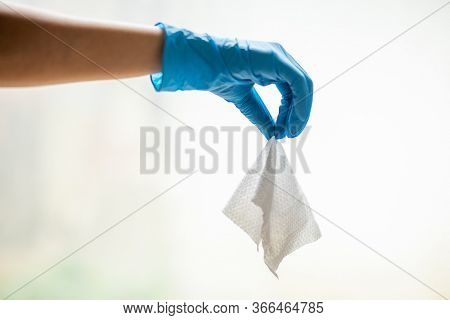 Wet Wipes Should be Thrown in the Trash - not in the sawer. Hand in blue protective glove