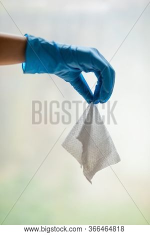 Wet Wipes Should be Thrown in the Trash - not in the sawer. Hand in blue protective glove