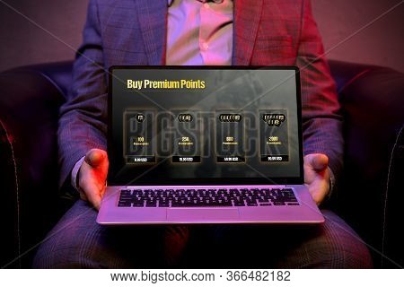 Micropayment System On The Display Of A Modern Laptop That Is Holds By An Elegant Man. Graphic Made 