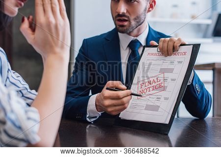 Cropped View Of Woman And Collector Pointing With Pen At Documents With Foreclosure And Final Notice