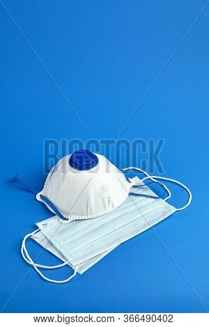 Face Masks, N95 Respirator Ffp2 On Blue Background With Copy Space, Selective Focus. Disposable 3-la