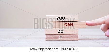 You Can Do It Wooden Blocks On Table Background, Businessman Hand Placing Or Pulling Wooden Block Wi