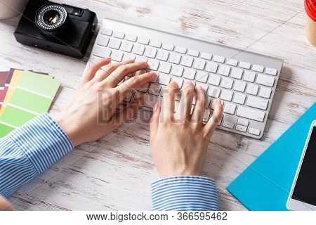 Freelancer Sitting At Desk And Typing On Wireless Keyboard. Business Occupation And Innovation Techn