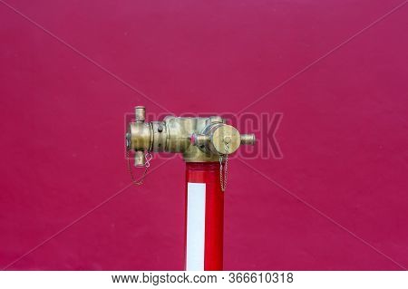 Red Fire Pump In Front Of Concrete Wall. Fire Safety Pump On Cement Floor Of Concrete Building. Delu