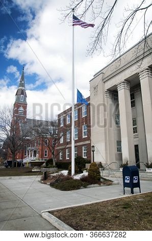 The Torrington Connecticut City Hall Exterior And Flags Blowing In The Wind, Litchfield County.