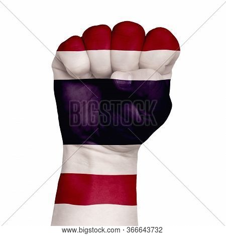 Low Key Picture Of A Fist Painted In Colors Of Thailand Flag.image On A White Background. Isolate