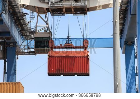 Crane Moving A Shipping Container To A Storage Platform.