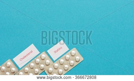 Lowering Blood Cholesterol With Statin Tablets, Blister Packs With Pills On A Blue Background