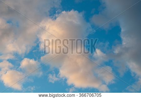 Dramatic Cloudscape Sky With Dark Storm Clouds, Blue Sky And Orange Pink Tinted Clouds.  Great For B