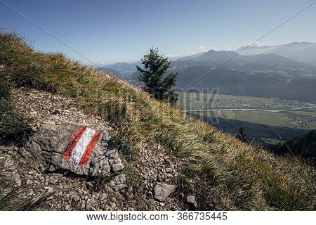 Trail Marker In The Austrian Alps With The Inntal Valley Visible In The Distance. Tirol, Austria.