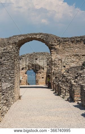 Italy, Lombardy - August 05 2018: The View Of Roman Ruins Grotte Di Catullo With Lake Garda On Backg