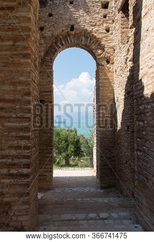 Italy, Lombardy - August 05 2018: The View Of Roman Ruins Grotte Di Catullo With Lake Garda On Backg