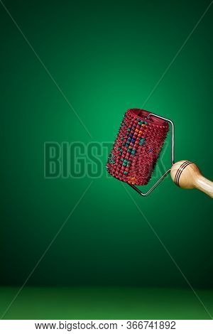 Massager With Red Drum, Tree Handle And Metal Needles On Green Background. Is Groundless. Subject Ph