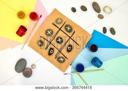 Top View Of Tic Tac Toe Game With Stones Marked With Naughts And Crosses. Childrens Art Project, A C
