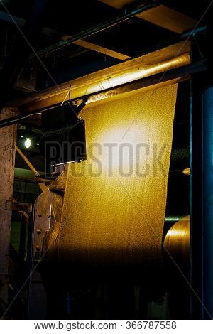 Close Up Of A Roll Of Rubber On A Machine In A Conveyor Belt Factory