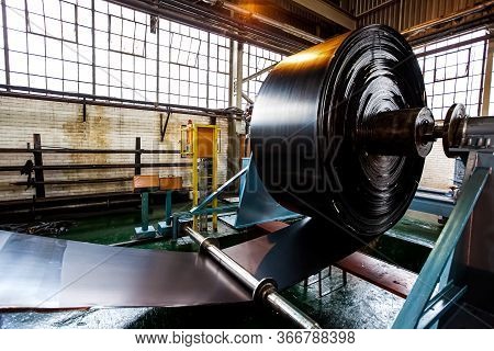 Close Up Of A Roll Of Rubber On A Machine In A Conveyor Belt Factory