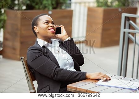 Communication. African-american Businesswoman In Office Attire Smiling, Looks Confident And Happy, B