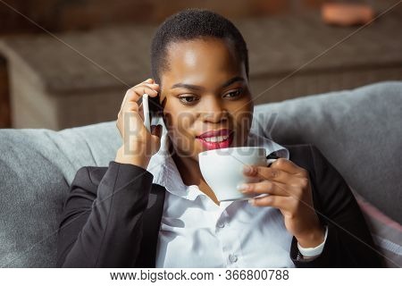 Business Call. African-american Businesswoman In Office Attire Smiling, Looks Confident And Happy, B