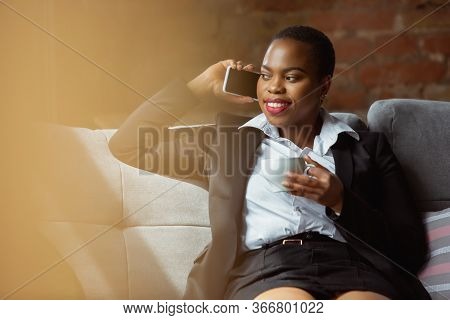 Business Call. African-american Businesswoman In Office Attire Smiling, Looks Confident And Happy, B