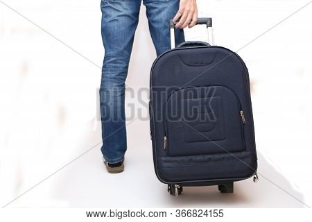 A Man Goes On Vacation And Pulls A Suitcase From The Back.