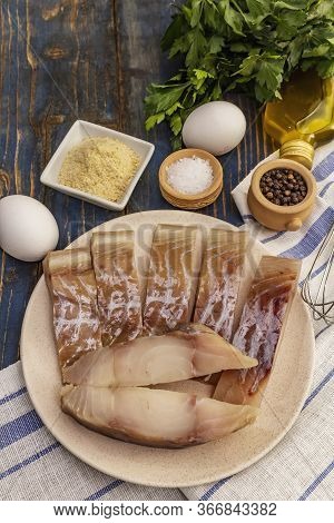 Raw Fillet Of Saithe And Frying Ingredients. Fresh Slices On A Plate, Spices, Eggs, Oil, Breadcrumbs