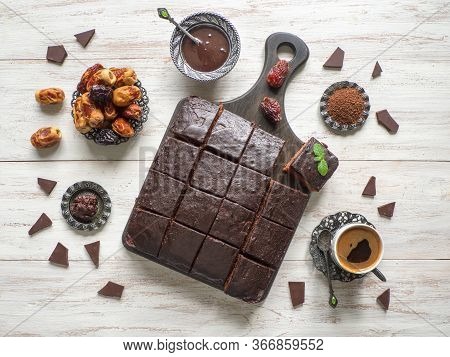 Chocolate Brownie Cake With Dates, Dessert On White Wooden Background. Top View, Copy Space.