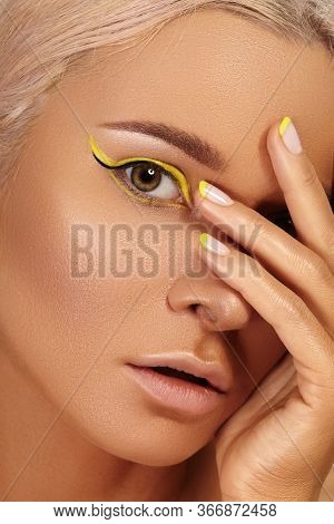 Beautiful Tanned Skin Woman. Sunburnt Girl Face With Natural Bronzed Make-up, Yellow Manicure. Sexy