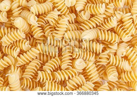 Dried Corkscrew Shaped Pasta Or Eliche Pasta Over White Background. Close Up