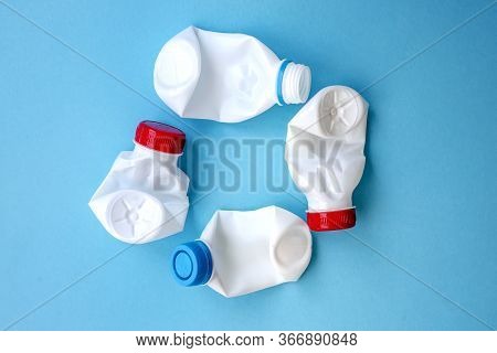 White Plastic Bottle On A Solid Blue Background For Recycle Waste. Waste Separation Concept. Protect