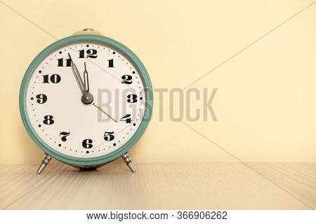 Antique Analog Clock With Hands Set At 12:00. 11:55 A.m. 00:00 12:00 24:00. The Alarm Clock Is On Th